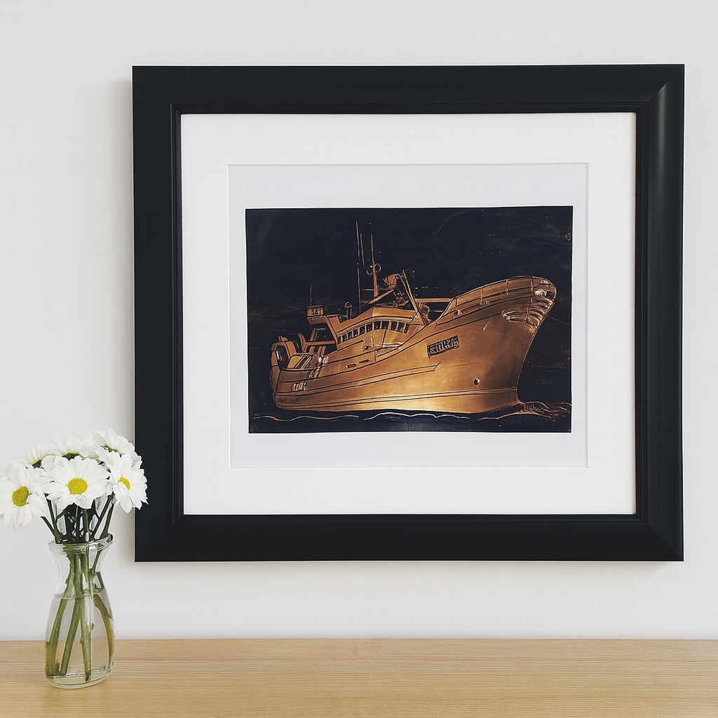 Framed copper relief artwork of a fishing boat, displayed in a cozy nautical-themed living space with soft lighting and ocean-inspired décor."