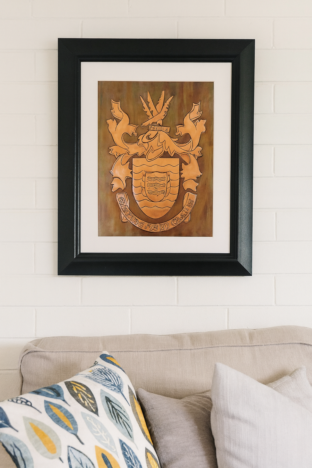 Framed copper artwork of the Donegal County and Council crests, inspired by the O'Donnell royal arms, displayed against a softly lit, neutral-toned background, blending heritage craftsmanship with contemporary interior decor.