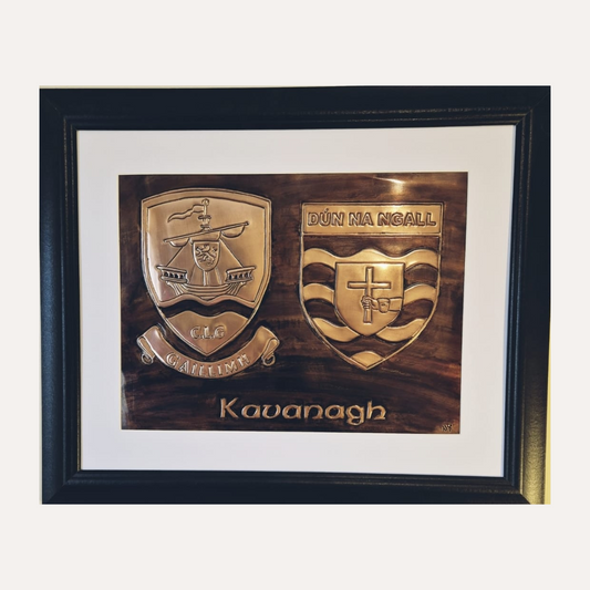 Personalised double copper sports crest wall art displayed in a modern living room, featuring Galway and Donegal GAA emblems and engraved surname.