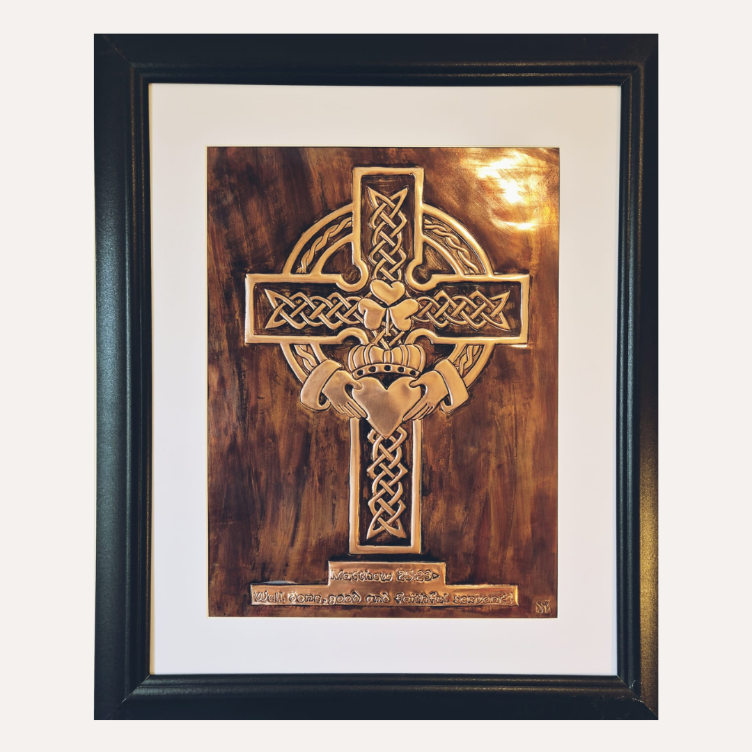 Framed handcrafted copper Celtic Cross with shamrock emblem and intricate Irish knotwork, finished with a rich patina background.