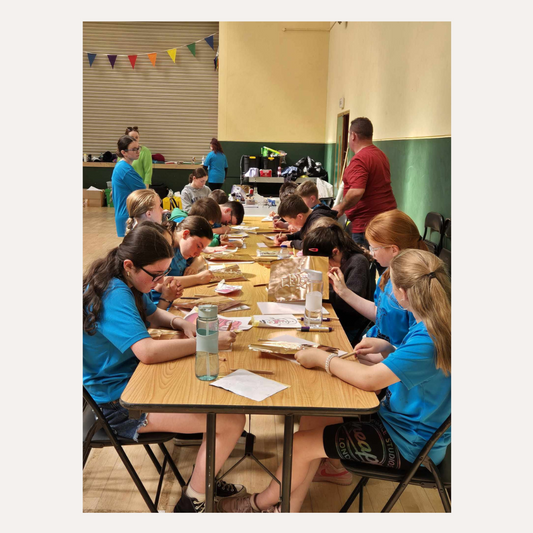 Kids creating handmade copper art pieces during a traditional Irish craft workshop"