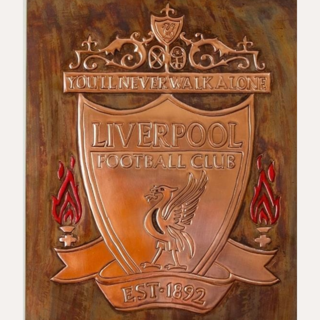 Framed handcrafted copper artwork of the Liverpool Football Club crest with "You'll Never Walk Alone" motto, featuring embossed detailing and flame accents.