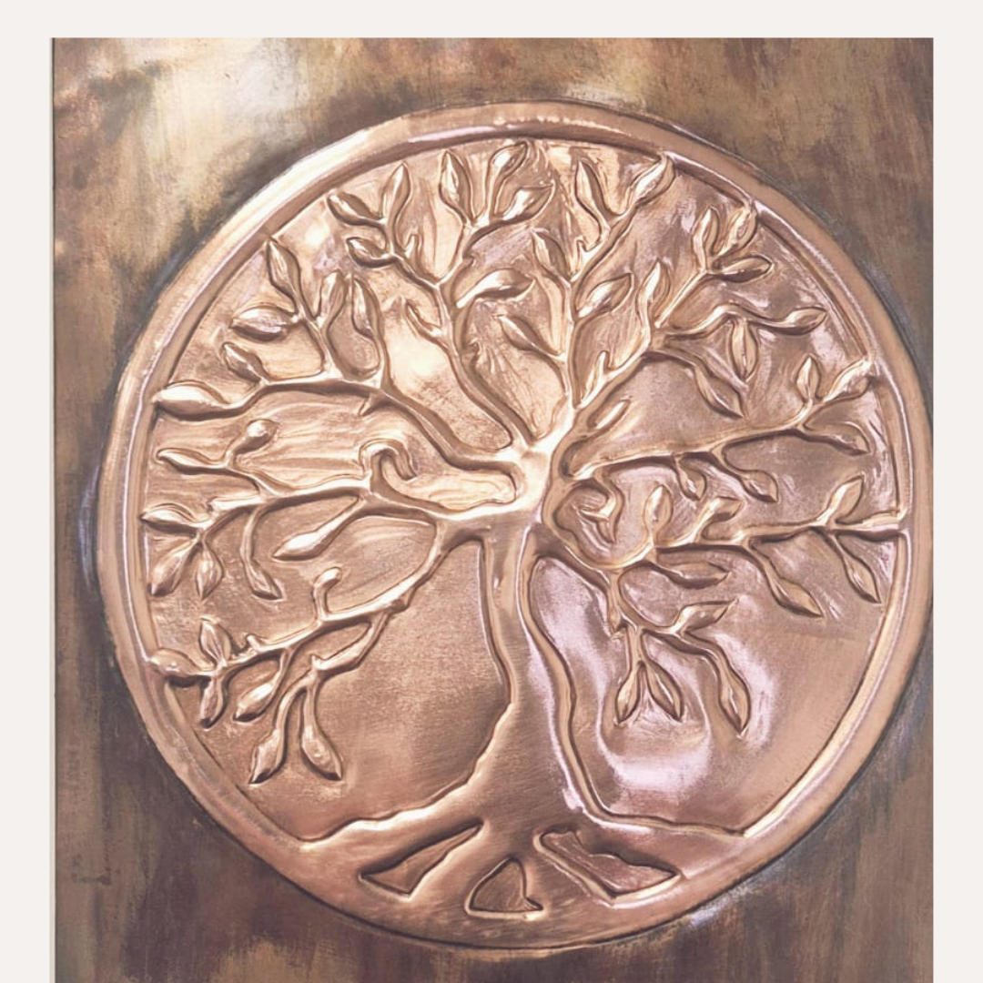 Close-up of hand-pressed copper Tree of Life artwork showing detailed branches, roots, and warm patina finish.