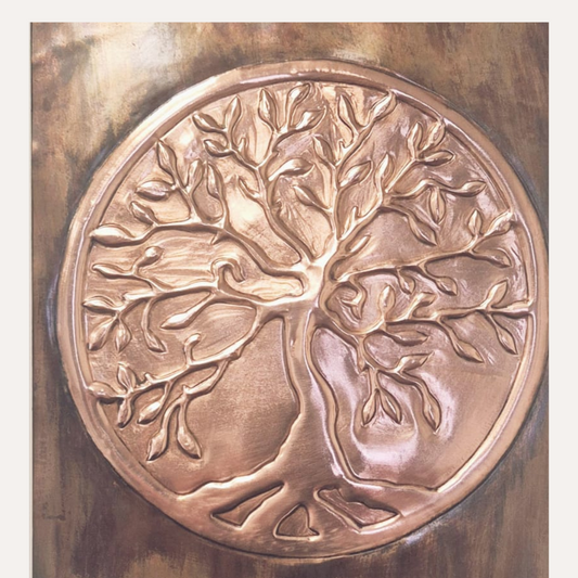 Close-up of hand-pressed copper Tree of Life artwork showing detailed branches, roots, and warm patina finish.