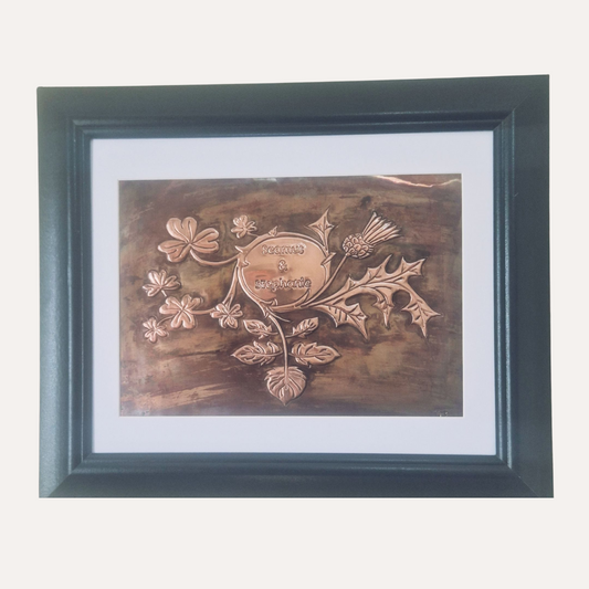 Framed handcrafted copper artwork featuring intertwined shamrock and thistle with engraved names – Irish and Scottish heritage design