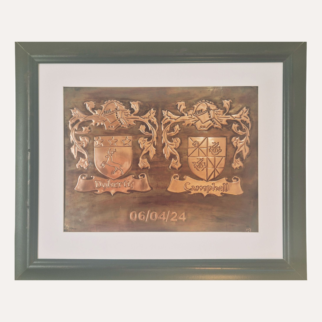 Handcrafted copper plaque featuring Doherty and Campbell family crests with ornate detailing and scroll banners
