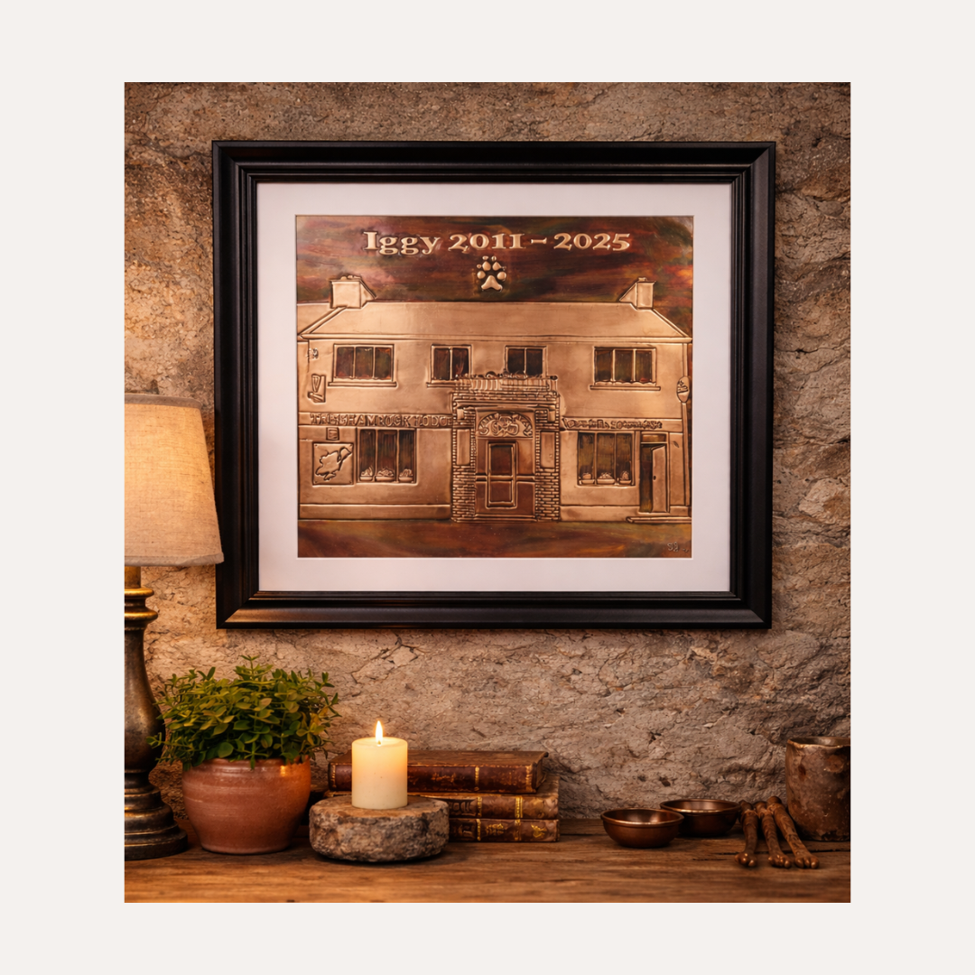 A beautifully lifestyle image of a  bespoke copper memorial piece created in memory of Iggy (2011–2025), the much-loved dog of The Shamrock Bar, Falcarragh. Handcrafted in copper, this artwork captures the spirit of the place and honours Iggy’s special place at its heart.
