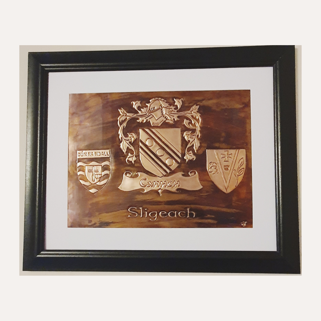 Handcrafted copper artwork featuring the Cannon family crest with Donegal and Sligo county shields, framed and polished with a rich traditional patina.