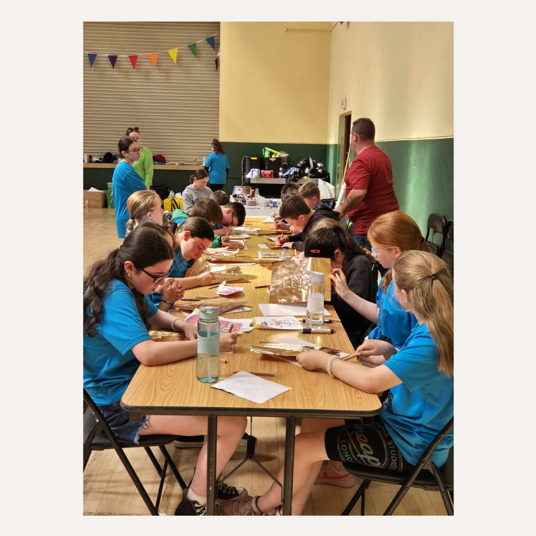 Kids creating handmade copper art pieces during a traditional Irish craft workshop"