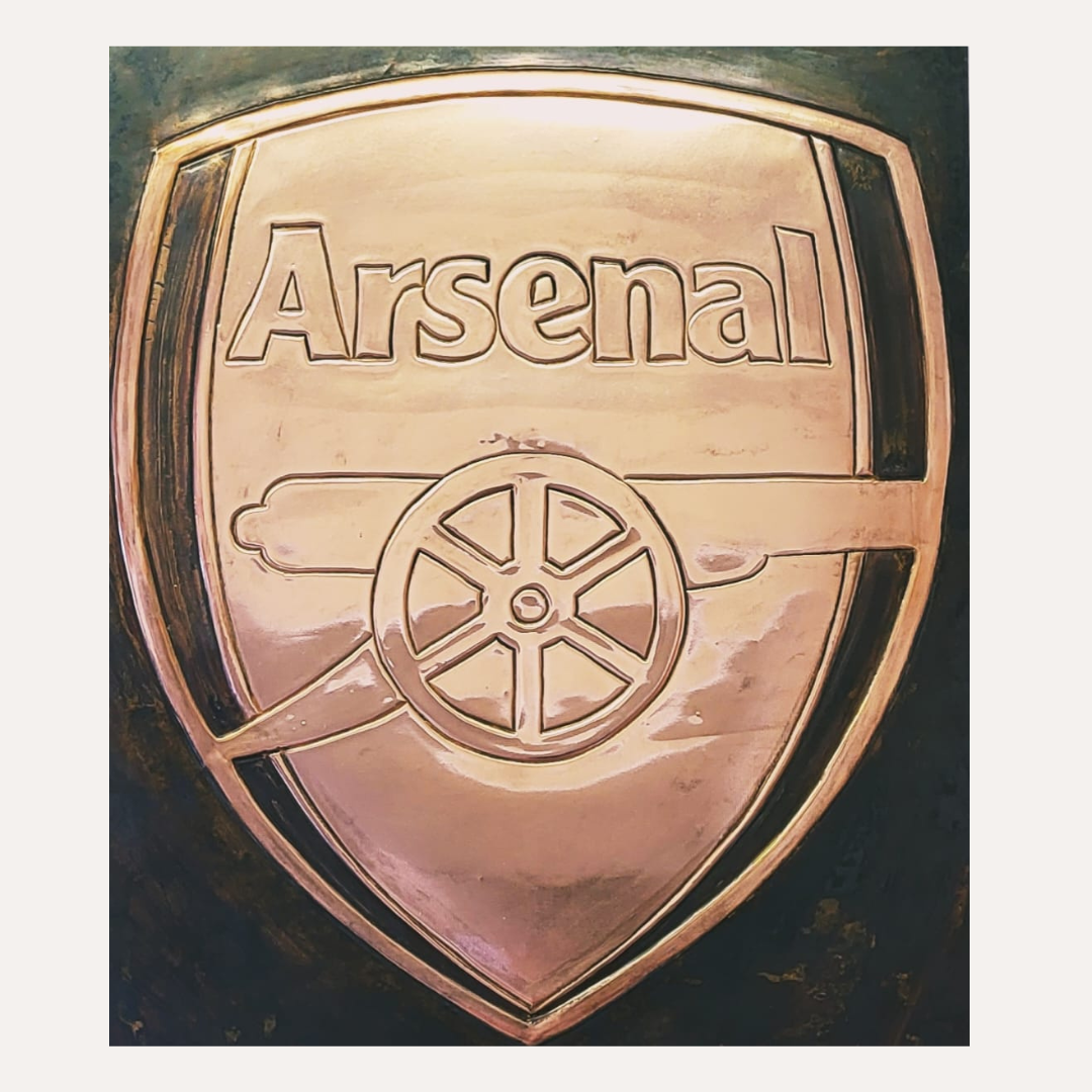 Handcrafted copper artwork featuring the Arsenal Football Club crest with its iconic cannon emblem, framed and ready for display.