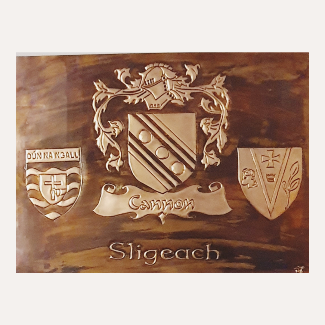 Handcrafted copper artwork featuring the Cannon family crest with Donegal and Sligo county shields, framed and polished with a rich traditional patina.