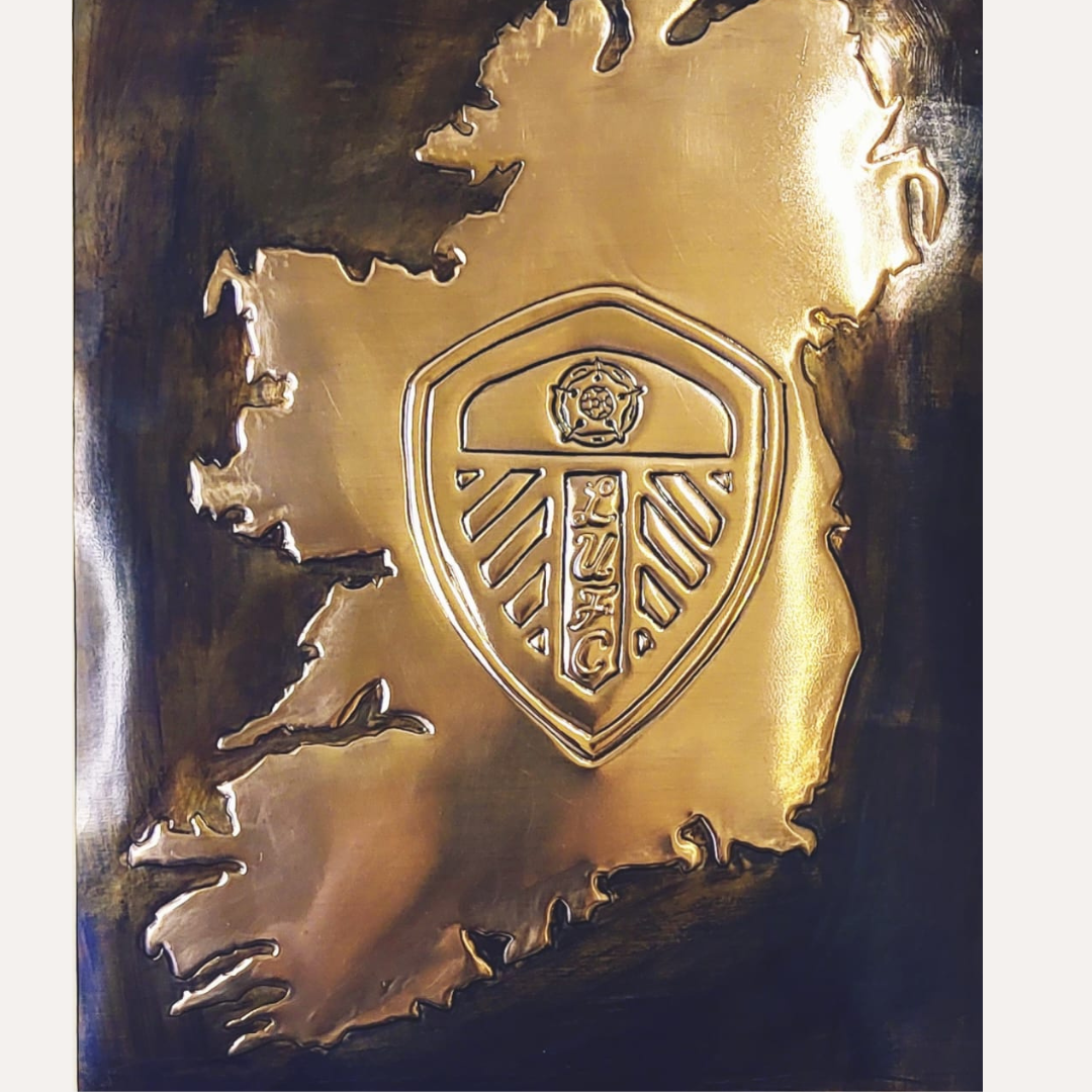 Handcrafted copper artwork featuring the Leeds United crest embossed within a map of Ireland, personalized with the name Callaghan, symbolizing Irish pride and football loyalty