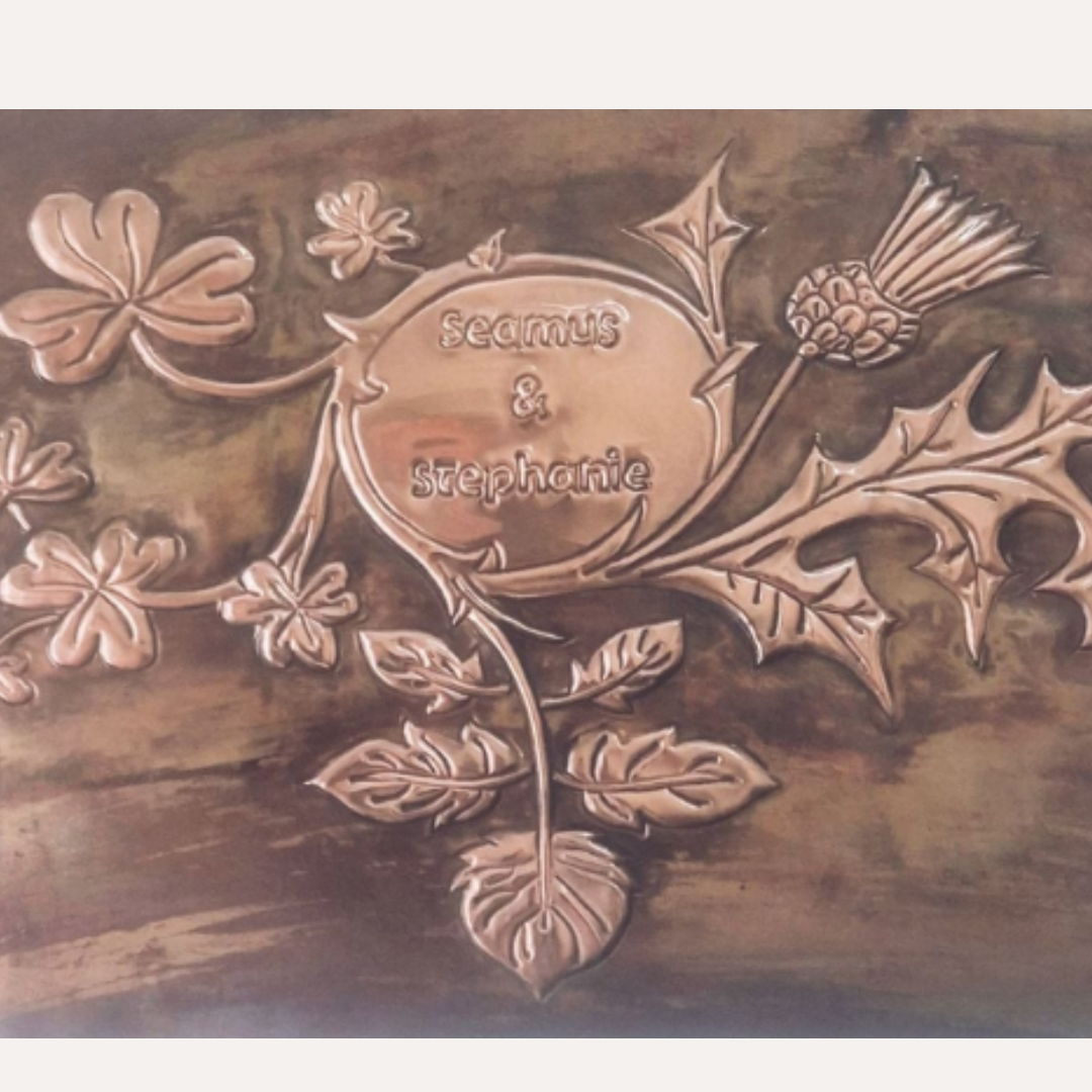 Framed handcrafted copper artwork featuring intertwined shamrock and thistle with engraved names – Irish and Scottish heritage design
