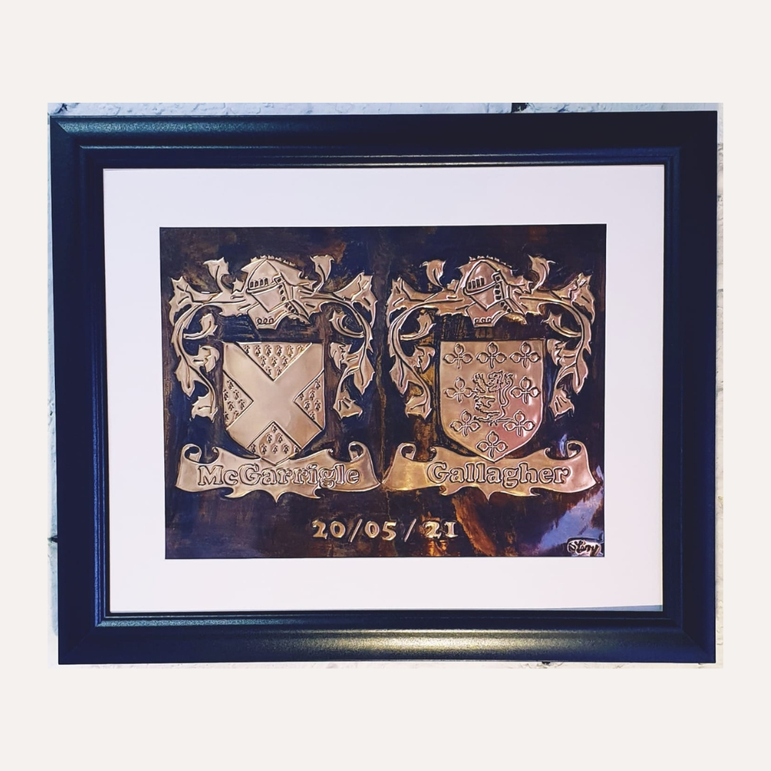 Framed handcrafted copper double family crest plaque featuring the McGarrigle and Gallagher coats of arms with a personalised date engraving.
