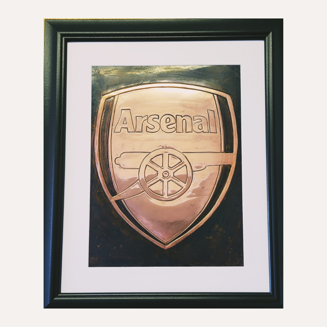 Handcrafted copper artwork featuring the Arsenal Football Club crest with its iconic cannon emblem, framed and ready for display.