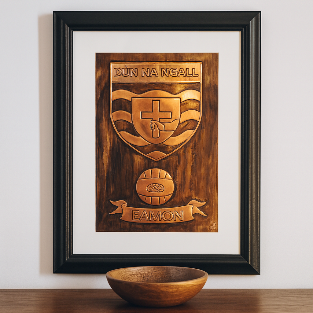 Framed copper Donegal GAA crest plaque with personalised name "Eamon" displayed on a white wall above a wooden table with bowl