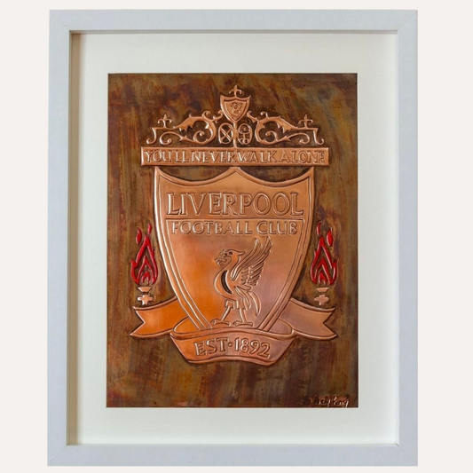 Framed handcrafted copper artwork of the Liverpool Football Club crest with "You'll Never Walk Alone" motto, featuring embossed detailing and flame accents.