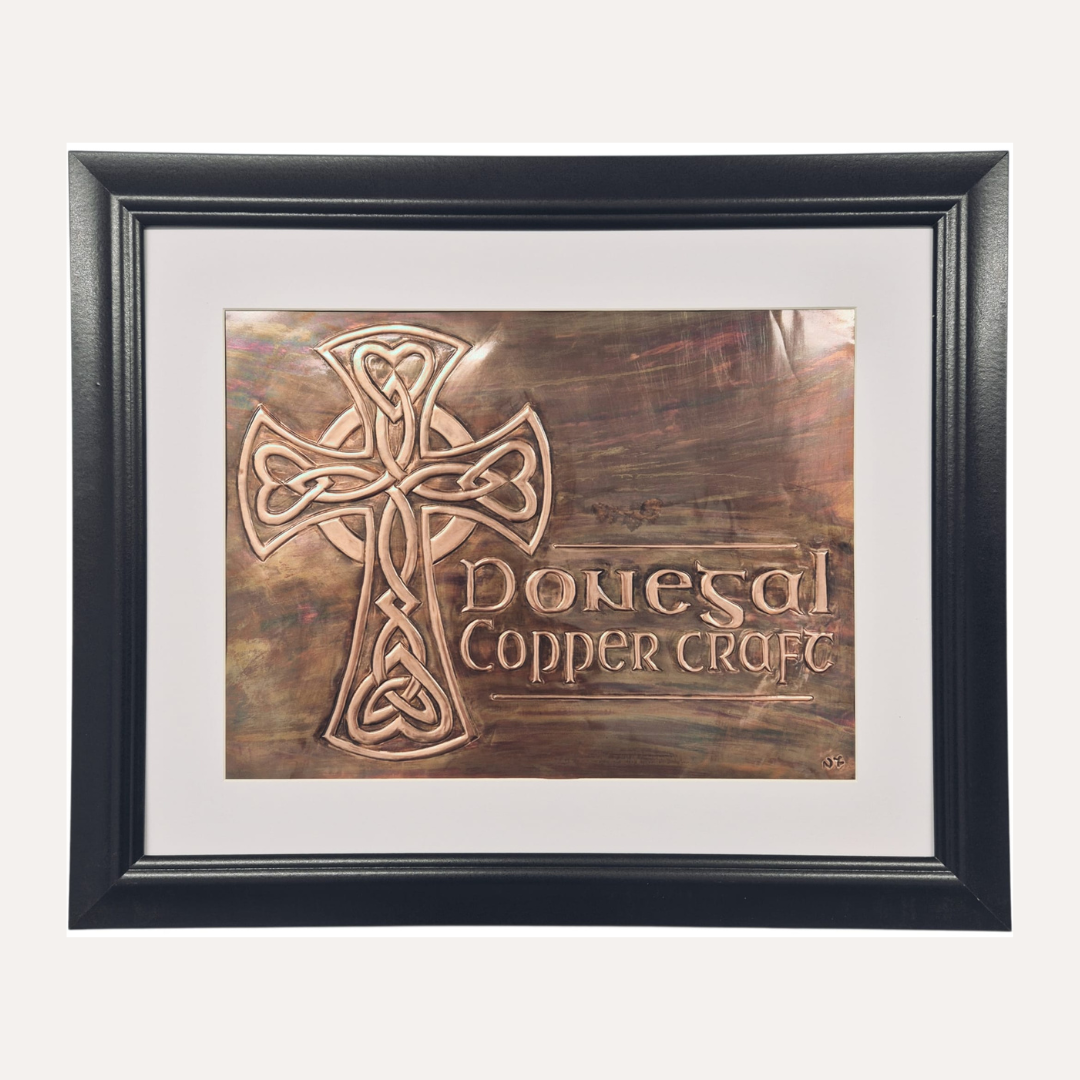 The Donegal Copper Craft logo is a handcrafted copper emblem inspired by Irish heritage, featuring a traditional Celtic cross with intricate knotwork and a rich, aged patina finish. Each logo is individually embossed by hand, giving it depth, character, and a timeless sense of craftsmanship.